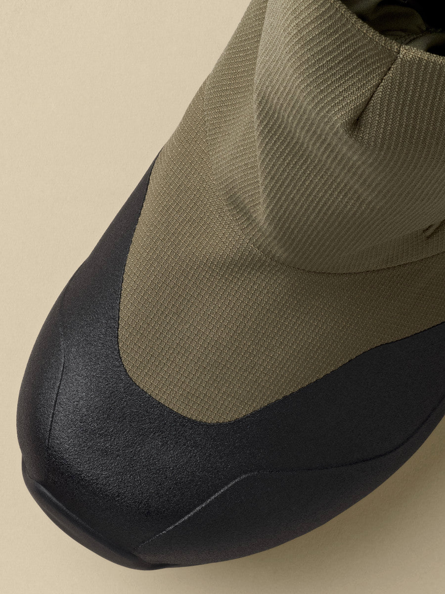 Close-up of the Arcteryx PostTour in Tatsu/Black showing the black rubber toe rand meeting the olive textured fabric upper