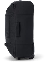 Dakine 365 Carry-On Roller Bag LT 40L in Black, side view showing the padded grab handle, slim profile and wheel housing