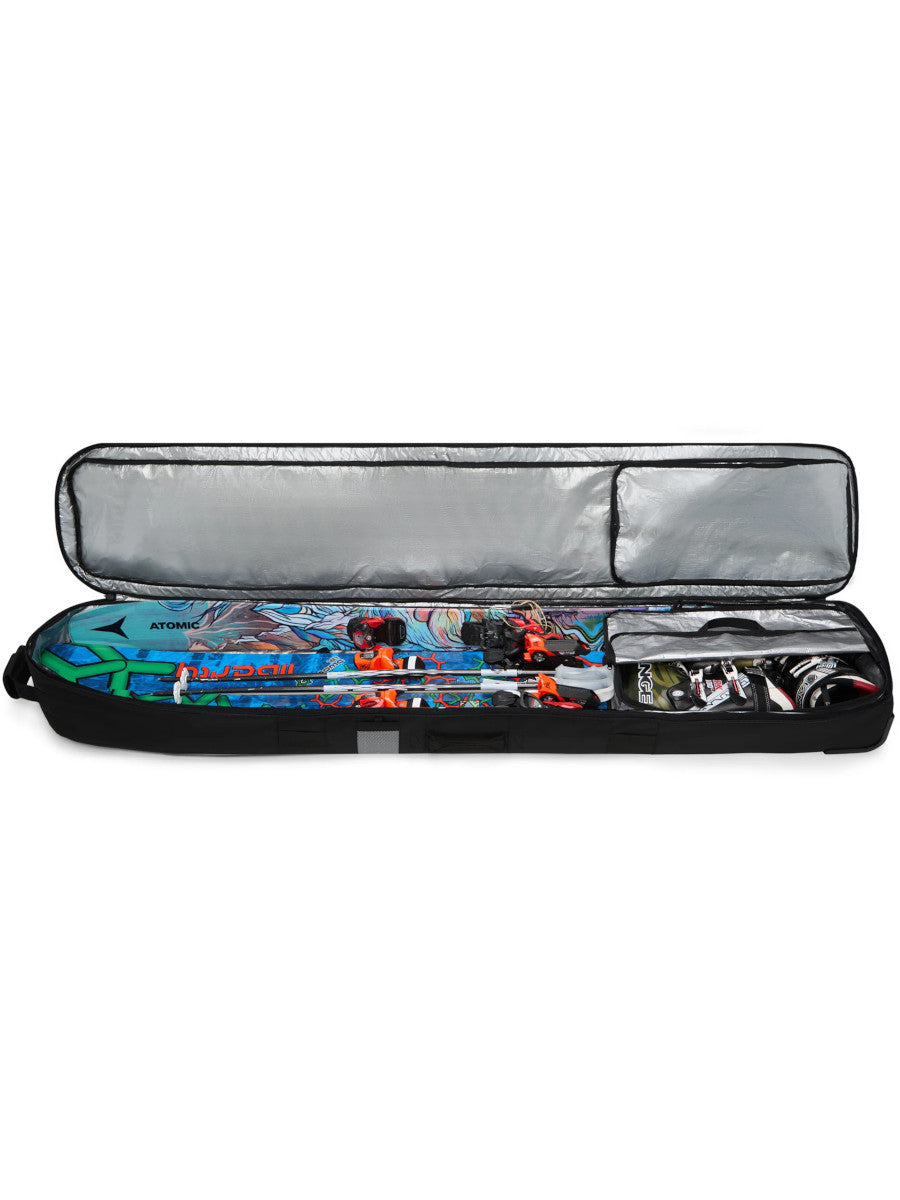 Dakine Fall Line Ski Roller Bag 190cm in Black Coated, fully unzipped to reveal the silver lined interior packed with skis and boots