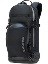 Dakine Heli 2.0 Pro Pack 20L in Black with a helmet held in the stretch front carrier, three-quarter view showing the side straps