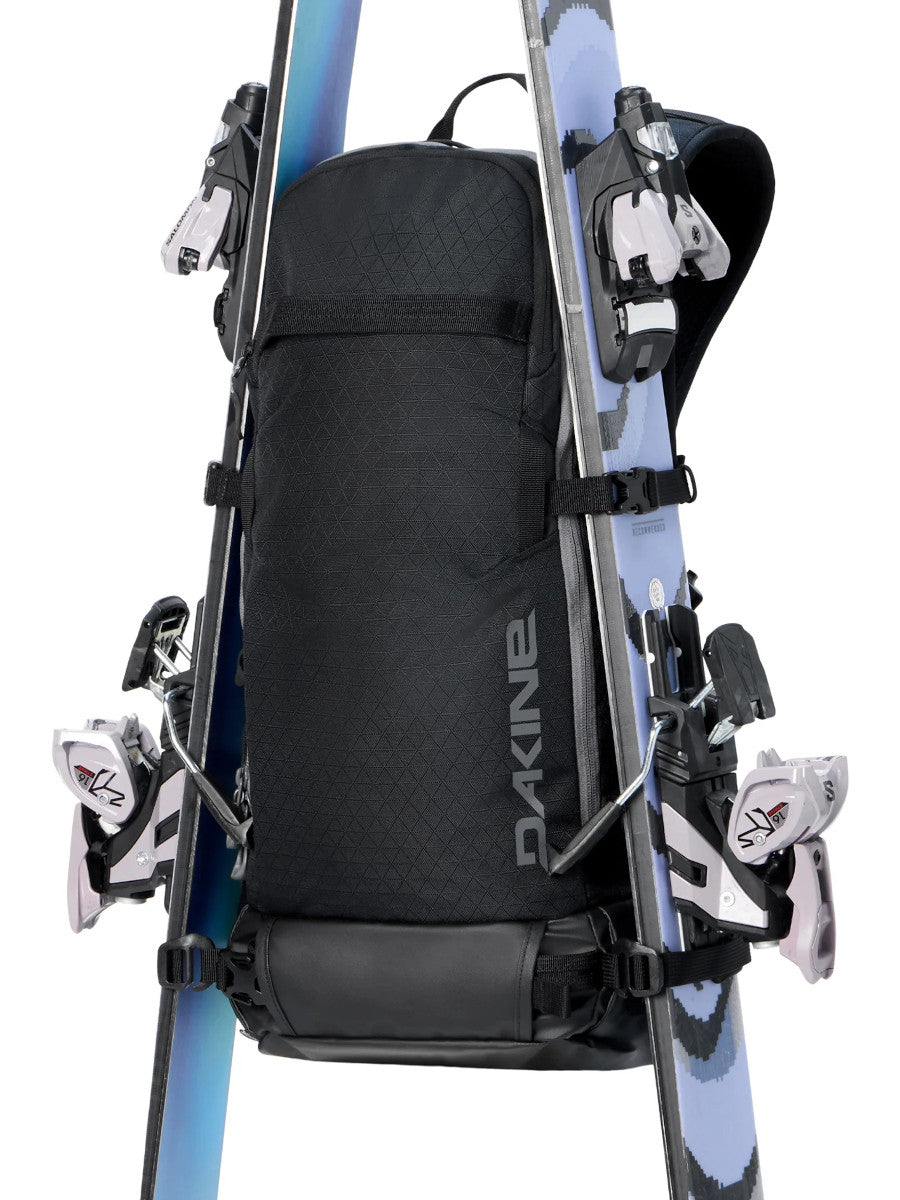 Dakine Heli 2.0 Pro Pack 20L in Black with a pair of skis attached in A-frame carry on either side of the pack, front view