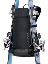 Dakine Heli 2.0 Pro Pack 20L in Black with a pair of skis attached in A-frame carry on either side of the pack, front view