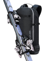 Dakine Heli 2.0 Pro Pack 20L in Black with touring skis strapped diagonally across the front, side three-quarter view
